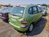 a green car parked in a parking lot with other cars
