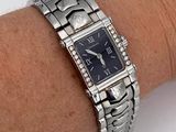 wrist shot of a lady ' s wrist with a watch on it
