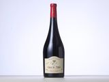 a bottle of red wine sitting on top of a table
