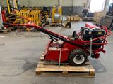 a small machine that is sitting on a pallet in a warehouse