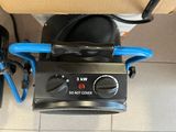a black and blue machine sitting on a tiled floor