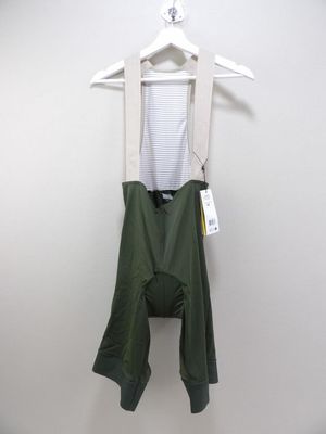 the bib shorts are green and white with a white top
