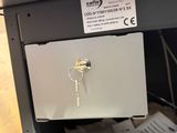 a laptop computer sitting on top of a desk with a key in it