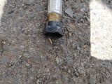 a pipe that is laying on the ground next to the street