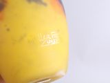 a person holding a glass of orange juice in their hand