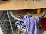 a small table with a chair and a pot on top of it