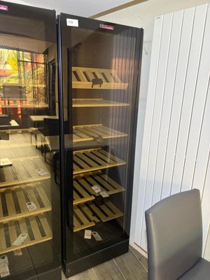 a glass door that has a wine cooler inside of it