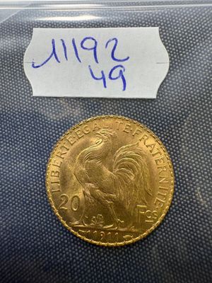 a close up of a gold coin with a label on it
