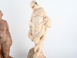 two statues of a man and a woman standing next to each other