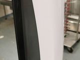 a white and black toilet paper dispenser on a black stand