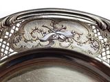 a silver plate with a bird on it