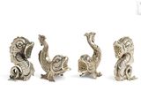 three silver figurines of birds and a fish on a white background