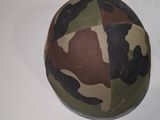 a ball with a camouflage pattern on it sitting on a table