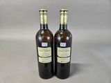 two bottles of wine sitting next to each other on a table