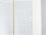 an open book on a table with a white background