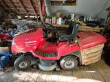 a red lawn mower parked in a garage