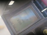 a close up of a digital clock on a motorcycle