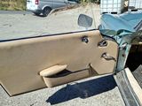 a car with the door open sitting in a parking lot
