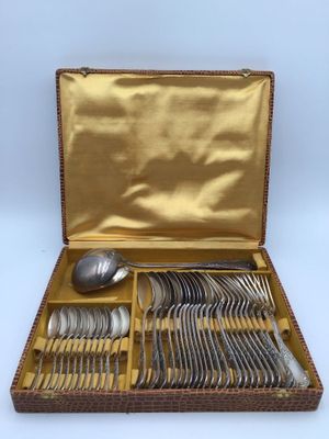 a box with silverware in it on a white surface