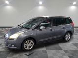 a picture of a grey minivan parked in a garage