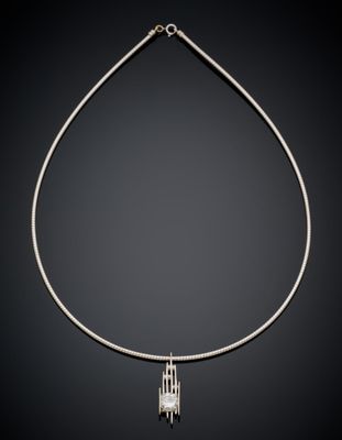 a silver necklace on a black background