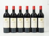 six bouteilles de vin rouge alignées sur une surface blanche