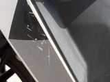 a close up of a motorcycle with a broken front fender