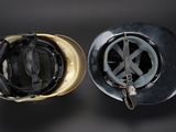 two helmets that are next to each other on a black background