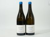 two bottles of wine sitting next to each other on a table