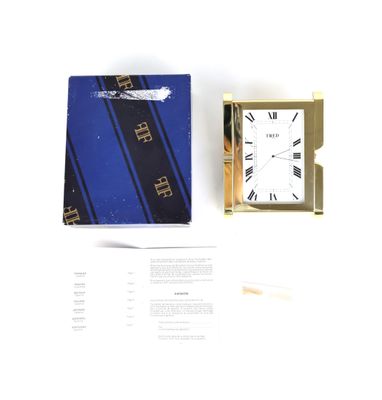 une boîte contenant une horloge, posée sur une table