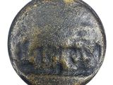 a close up of a coin with a face on it