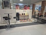 tables and stools in a room with a tiled floor