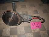 a broken drill on the floor next to a pink sign