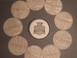 several coins are arranged in a circle on a table