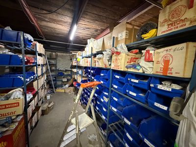 a room filled with lots of blue bins and boxes