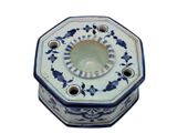 a blue and white octagonal box with a flower design on it