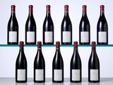 six bottles of red wine sit on a shelf in front of a white background