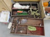 a wooden box filled with assorted items on the floor