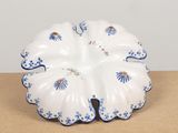 a white plate with blue flowers on it on a table