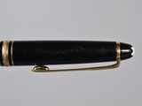 an image of a pen with a black body and gold trim