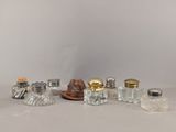 five glass salt and pepper shakers sitting on a table