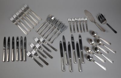 a lot of silverware on a table with forks and spoons