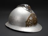 a silver helmet with a gold emblem on it