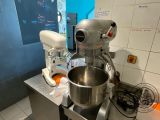 a silver mixer sitting on a counter in a kitchen