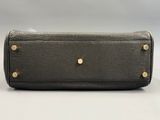 a black leather purse with gold studded handles