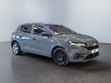 the grey car is parked in a white room with a black floor
