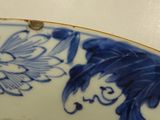 a blue and white plate with a flower design on it