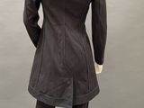the back view of a mannequin wearing a black coat and pants