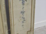 two framed pictures of flowers on a white wall