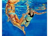 a painting of two women swimming in a pool